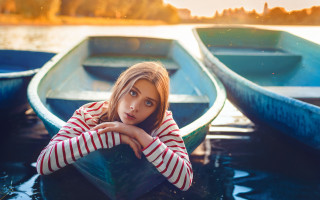 Woman sitting boat serious portrait - serious free wallpaper for desktop