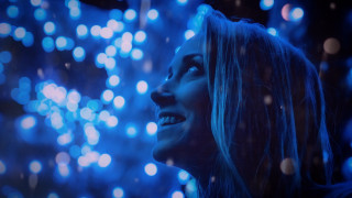 Woman smiling fireworks blue lights - looking free wallpaper