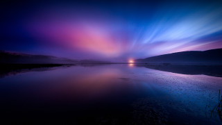 Lake purple blue sky horizon - a light house in the distance free wallpaper