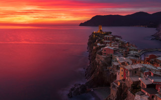 Sunset village cliff ocean mountains - mystical free wallpaper