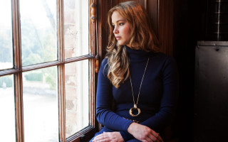 Woman sitting window curtains street - a window sill free wallpaper
