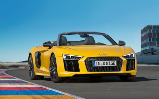 Yellow sports car race track 17 - a sky background and a building in the background free wallpaper