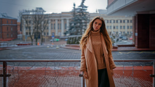 Woman balcony coat urban cityscape - fashion free wallpaper
