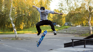 Man flying skateboard park trees - action scene free wallpaper