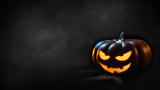 Carved pumpkin glowing eyes gothic - dark background free wallpaper