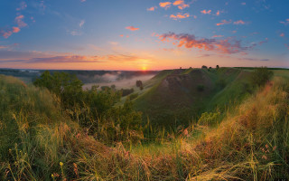 Sunset grassy hill valley clouds - artur tarnowski free wallpaper
