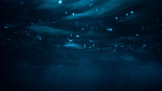 Dark blue ocean bubbles surfer - a surfboard free wallpaper