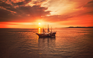 Boat sunset clouds city mountains - top of a body free wallpaper for desktop
