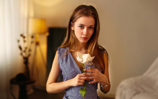 Woman holding flower serious portrait - a woman holding free wallpaper