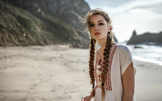 Woman beach braids ocean rocks - a beach near the ocean free wallpaper