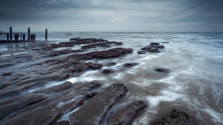 Night beach water rocks pier - rich moody colour free wallpaper