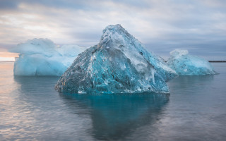 Large iceberg ocean cloudy sky - ice free wallpaper