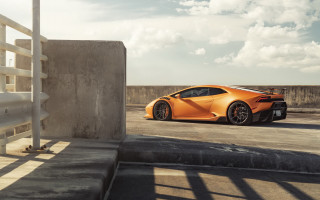 Orange sports car side profile - a concrete wall free wallpaper