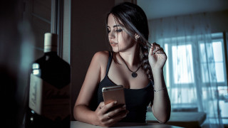 Woman sitting table cellphone wine - her hand and a bottle of wine free wallpaper