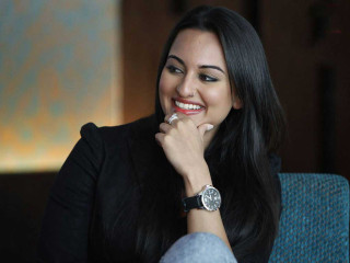 Woman smiling holding watch looking - her wrist free wallpaper