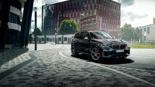 Black bmw suv city street 2 - a tall building free wallpaper