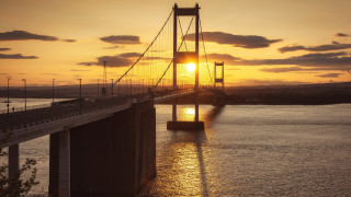 Sunset bridge water clouds cityscape 3 - a body of water below free wallpaper