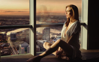 Woman sitting window sill city 3 - the city free wallpaper