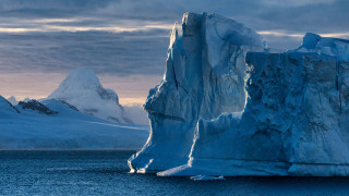 Iceberg mountain ocean cloudy sky - a large iceberg free wallpaper