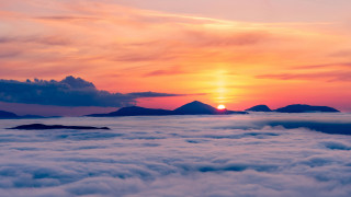 Sunset sea clouds mountains city - orange sun free wallpaper