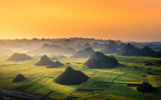 Green grass yellow sky mountains - a few cloud free wallpaper