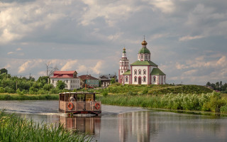 Boat river church cloudy sky - a cloudy day free wallpaper