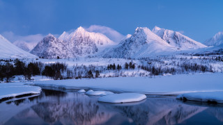 Snowy mountains lake forest rocks - the background and a lake in the foreground free wallpaper