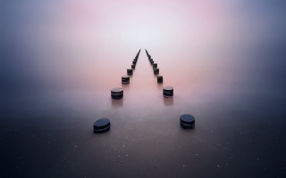 Black poles foggy water sky - symmetric balance free wallpaper