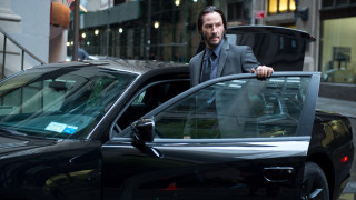 Man suit leaning car city - movie still free wallpaper