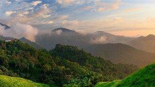 Lush green hillside clouds trees - a valley free wallpaper