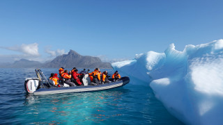 Boat people iceberg ocean mountains - promotional image free wallpaper