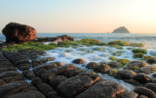 Rocky beach large rock water - a large rock in the middle of it free wallpaper