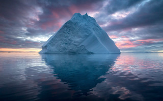 Iceberg sunset reflection cloudy sky - a large iceberg free wallpaper