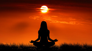 Woman sitting yoga sunset grass - a sunset free wallpaper