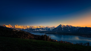 Mountain lake sunset city forest - orange glow free wallpaper