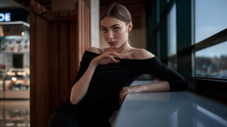 Woman sitting counter window sign - a window behind her free wallpaper