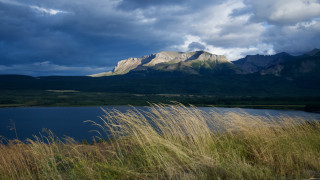 Lake mountains cloudy sky tallgrass - dramatic light free wallpaper