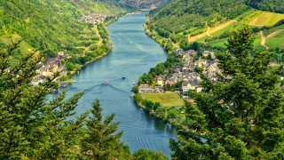 River hillside trees mountains houses - a lush green hillside free wallpaper