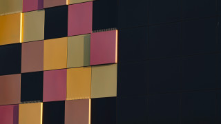 Multicolored facade clock building modular - the side of the building free wallpaper