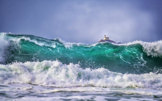 Lighthouse wave ocean stormy weather - a lighthouse in the distance free wallpaper