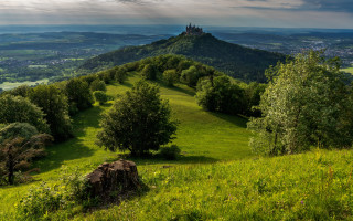 Castle hill trees lake mountains - a grassy hill free wallpaper