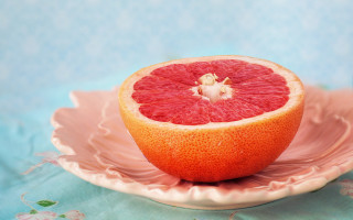 Grapefruit pink plate blue tablecloth - still free wallpaper