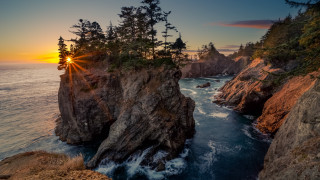 Sunset water trees rocks sky - a sunset over a body of water free wallpaper