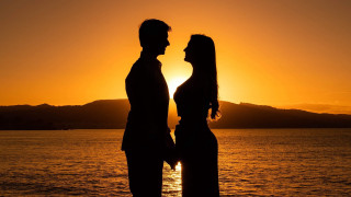 Sunset couple mountains water berndfasching - a couple standing next free wallpaper