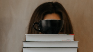 Woman hiding books coffee art - top of them free wallpaper