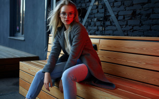 Woman glasses coat redlight brickwall - fashion photoshoot free wallpaper
