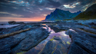 Mountain range reflection sunset boat - the foreground and a sunset in the background free wallpaper