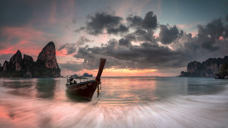 Mountain lake boat sunset city - the water near a mountain range free wallpaper