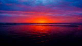Sunset ocean beach clouds horizon - a beach in the foreground free wallpaper