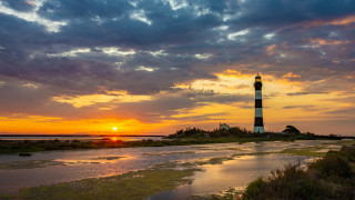 Lighthouse sunset clouds island beach - a small island free wallpaper